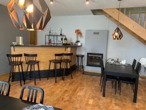 a kitchen and dining room with a table and chairs at Portoss in Ventspils