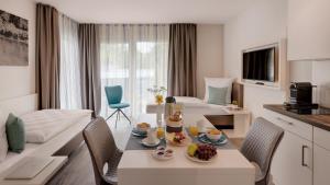 a hotel room with a table with food on it at Amper Art Boardinghouse in Fürstenfeldbruck