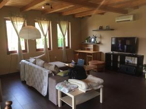 a living room with a couch and a tv at BB Szabó Villa in Balatonboglár