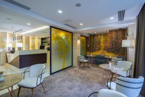 a lobby with tables and chairs and a bar at Hotel Atlas Abashidze in Tbilisi City