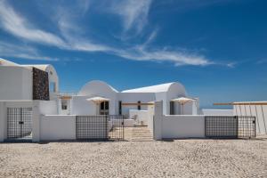 a white house on the beach with a blue sky at MILESTONE VILLAS in Megalokhori
