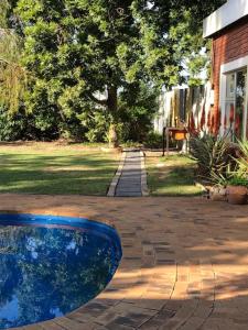 a blue bowl sitting on a brick walkway next to a house at The Vineyard East in Joostenberg Vlakte
