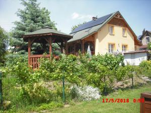 a house with a gazebo in the yard at Domek HANA in Radków