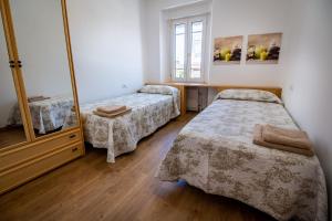 a room with two beds and a mirror at Pensión Casa do Gallo Sarria in Sarria +145 photos