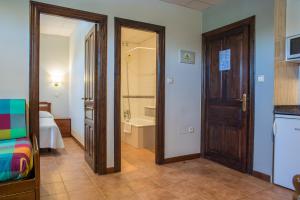 a room with a door and a bathroom with a tub at Apartamentos Capriccio in Santillana del Mar +40 photos