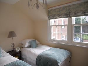 a bedroom with two beds and a window at The Auction House in Ryde