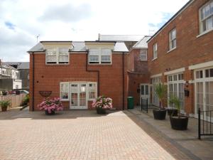 a brick building with potted plants in front of it at The Auction House in Ryde