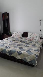 a bed with a quilt and pillows in a bedroom at Wow Rooms 4 You in Jabalpur
