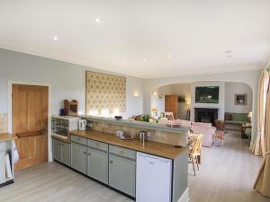 a kitchen and a living room with a table at Derwas in Abergele