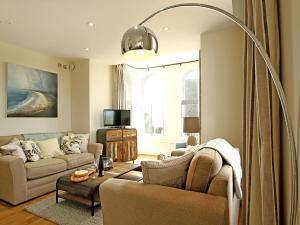 a living room with a couch and a table at Harlech Apartments - Branwen in Harlech