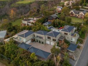 an aerial view of a large white house with blue roofs at Hillview Boutique Apartments in Knysna