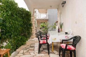 a patio with a table and chairs on a patio at Apartments Vodice Olga Matic in Vodice