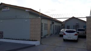 a house with a car parked in a parking lot at Boa vista, Olímpico - Apartamento mobiliado in Boa Vista