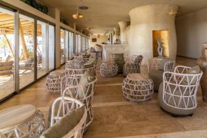 a restaurant with chairs and tables in a room at Zahara Beach & Spa by QHotels - Adults Recommended in Zahara de los Atunes