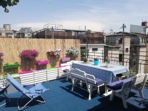 a patio with a table and chairs on a balcony at Hostel Inn Downtown in Belgrade