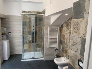 a bathroom with a shower and a toilet and a sink at Little Dreams Apartment in Trani