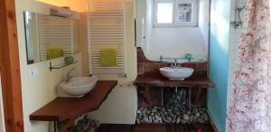 a bathroom with two sinks and a mirror at Forsthaus Merzalben Hostel in Merzalben +16 photos