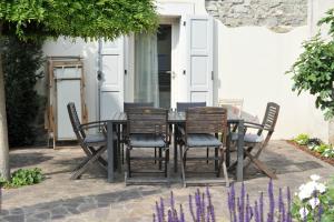 a dining table and chairs on a patio at Ambiente 90 in Levico Terme