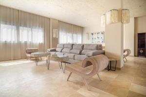 a living room with a couch and tables at Zahara Beach & Spa by QHotels - Adults Recommended in Zahara de los Atunes