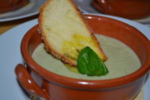 a bowl of soup with a sandwich in it at Colors Tastes in the Montagnola Senese in Valiano 