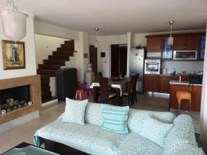 a living room and kitchen with a couch and a table at Luxury Sea View Vila 125m2 in Siviri