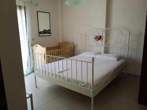 a bedroom with a white bed and a window at Luxury Sea View Vila 125m2 in Siviri