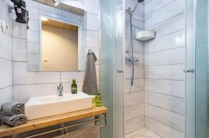 a bathroom with a sink and a shower at Astoria Heritage Suites in Budapest