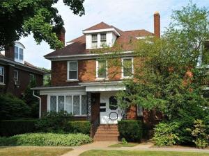 an old brick house with a white door at Second Street Suite in Clearfield