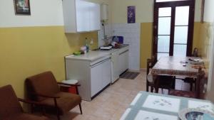 a kitchen with a counter and a table in it at Apartman Izvor in Vrnjačka Banja