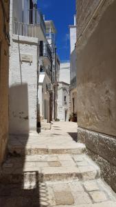 an alley with white buildings and a street sign at Nisea in Polignano a Mare