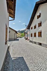a cobblestone street in a town with buildings at Chesa Violetta - S-chanf in S-chanf