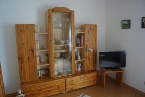 a large wooden cabinet with a tv in a room at Ferienwohnung Duß in Niederalteich