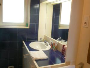 a bathroom with a sink and a mirror at Sunny holiday home in Provence with pool in Séguret +32 photos
