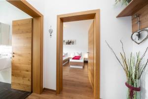 a hallway with a door leading to a living room at Pension Gschaider in Payerbach