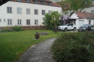 a white house with a fire hydrant in the yard at Ferienwohnung Duß in Niederalteich +3 photos