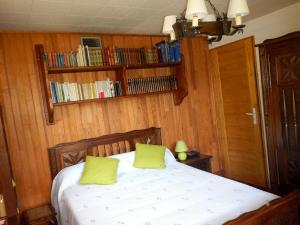 a bedroom with a bed with two lime green pillows at PRA BIQUET in Les Thuiles