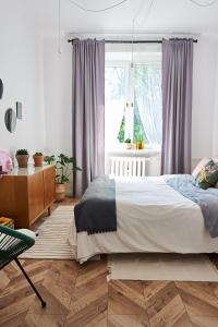 a bedroom with a large bed and a window at Kafka in Sandomierz