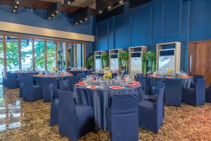 a room with long tables and chairs with blue walls at Samed Grandview Resort in Ko Samed