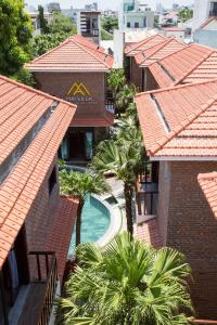 an overhead view of a resort with palm trees and a swimming pool at MAI Villa Da Nang in Danang