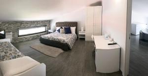 a bedroom with a bed and a desk in it at Pietra Bianca Rooms in Pachino