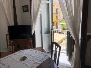 a room with a table and a view of a balcony at Residenza Amante Center in Tropea