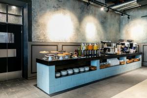 a kitchen with a counter with food on it at J24 Hotel Milano in Milan