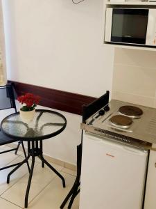 a small kitchen with a table and a microwave at Süle Apartments & Rooms in Balatonfüred