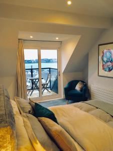 a bedroom with a large bed and a balcony at Hillrise B&B in Portrush