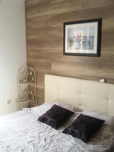 a bedroom with a white bed with a picture on the wall at Allegria in Umag