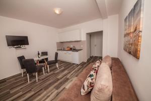 a living room with a couch and a kitchen at Blue Sea in Herceg-Novi