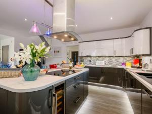 a kitchen with a vase of flowers on a counter at Kingfisher Lodge - 4 Bed Villa in Horning