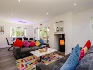 a living room with a couch and a fire place at Kingfisher Lodge - 4 Bed Villa in Horning