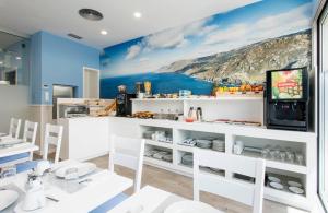 a restaurant with a mural of a coast at Hostal Praia Madalena in Cedeira