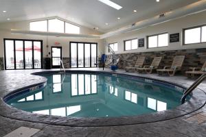 a large swimming pool in a building with windows at Sleep Inn & Suites Belmont - St. Clairsville in Belmont